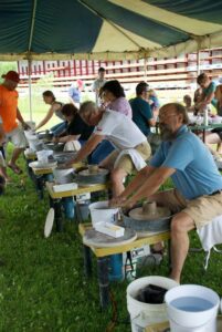 Participants during the Edgerton Pottery Festival enjoy getting their hands dirty!